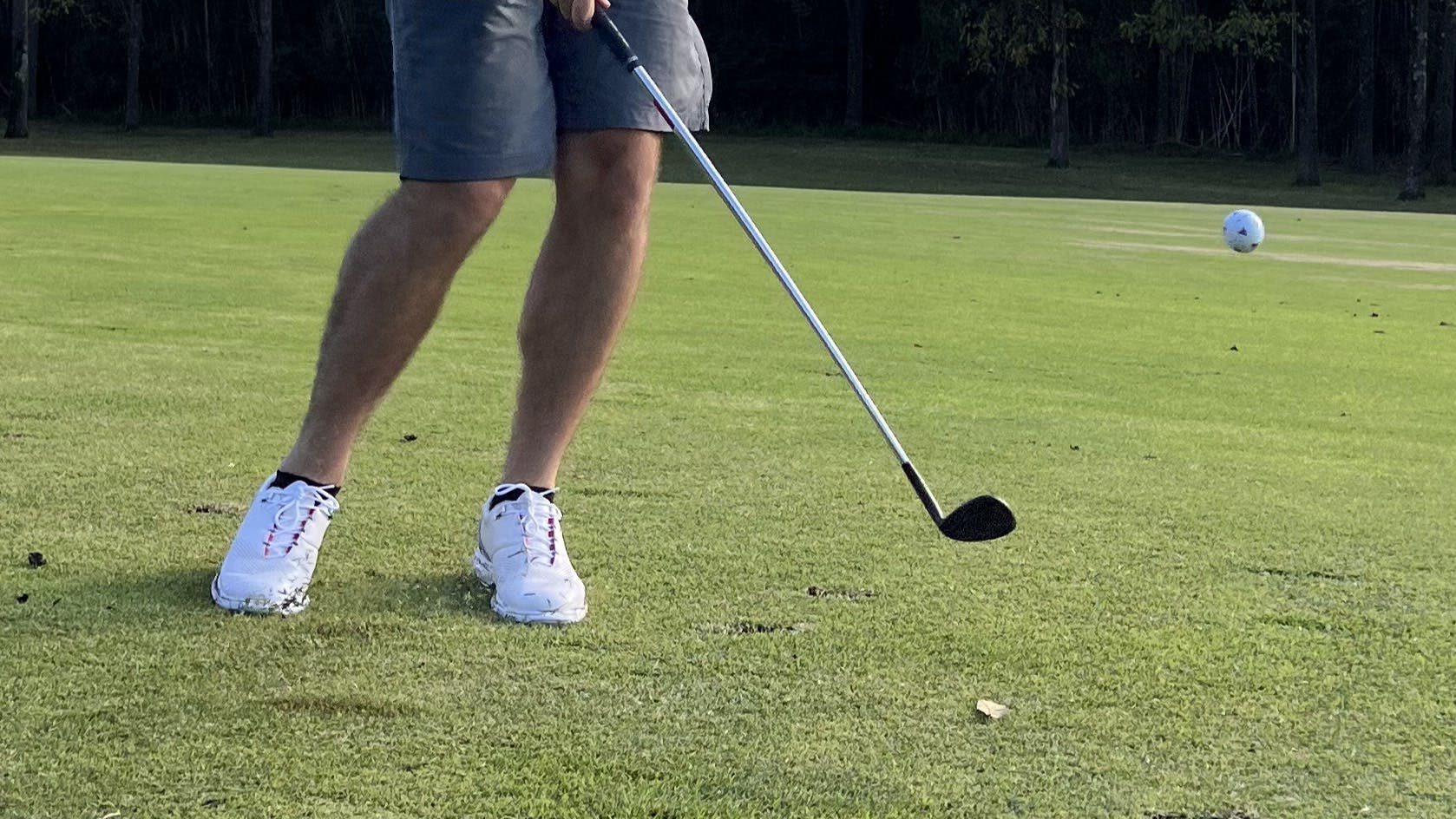 A golfer hitting a TaylorMade TP5 Pix 2.0 Golf Ball with a club. 