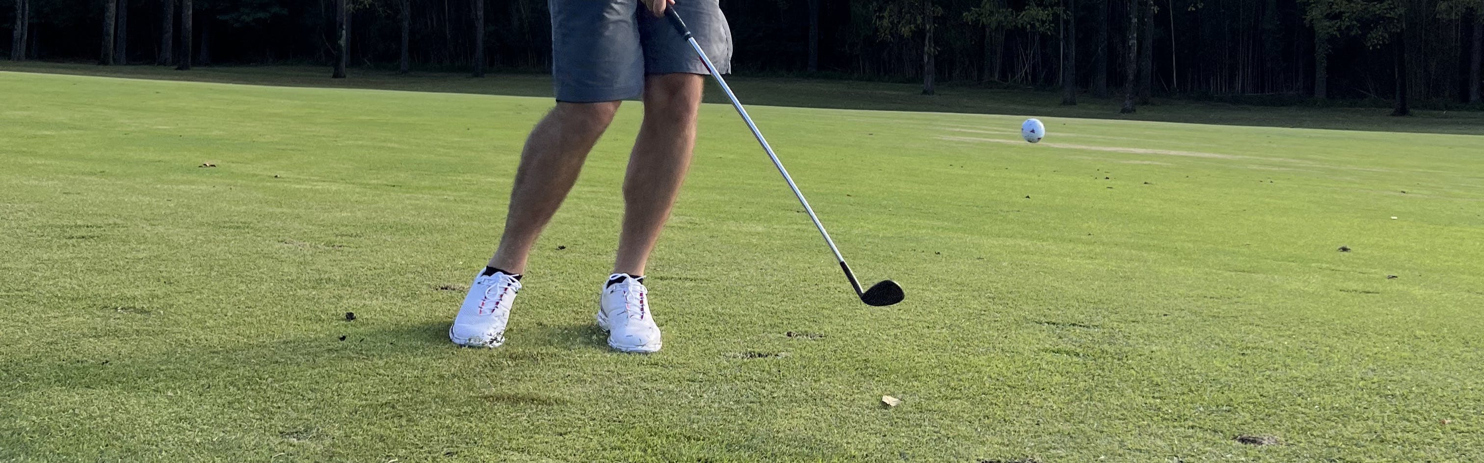 A golfer hitting a TaylorMade TP5 Pix 2.0 Golf Ball with a club. 