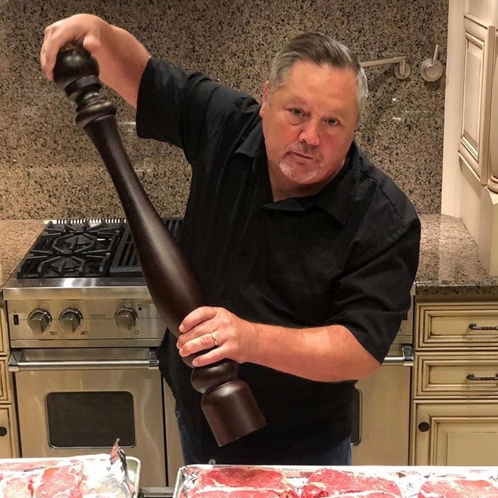 Waiter with a gargantuan pepper mill/grinder and a client with a