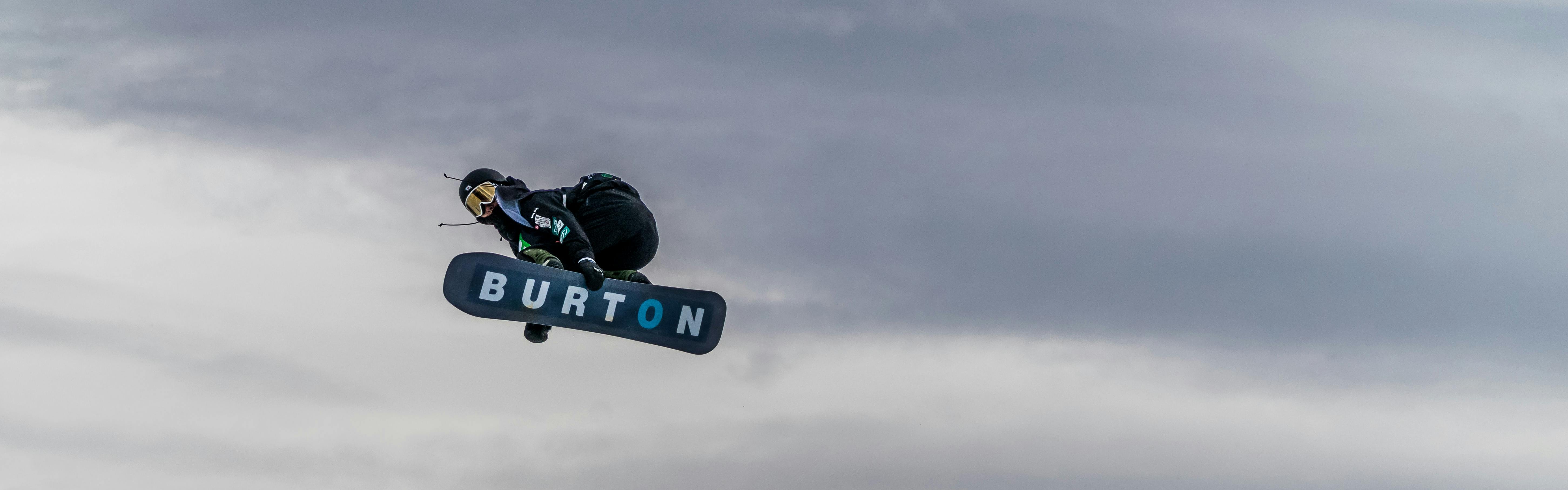 A snowboarder flies through the air
