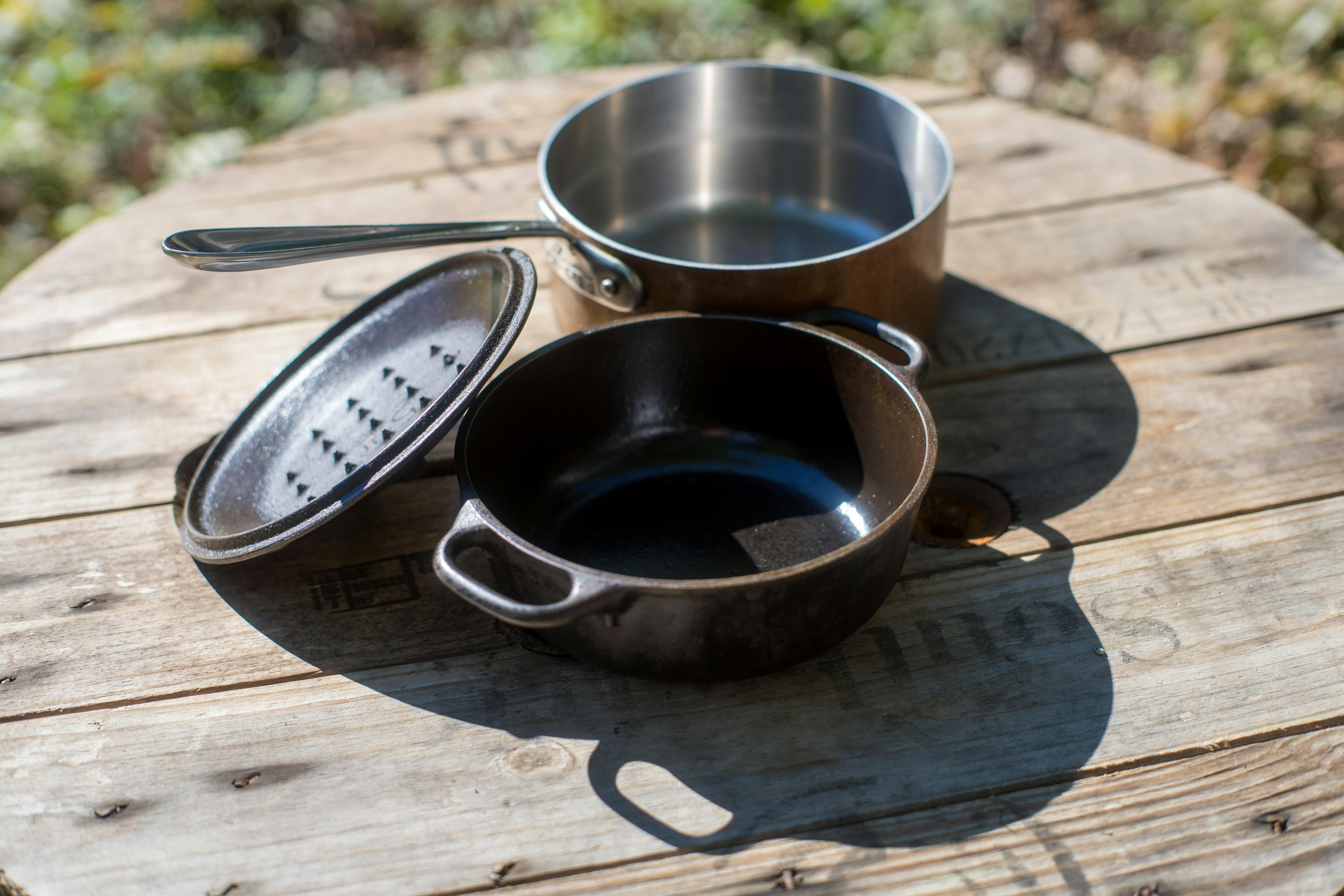 Dutch oven and stockpot on picnic table
