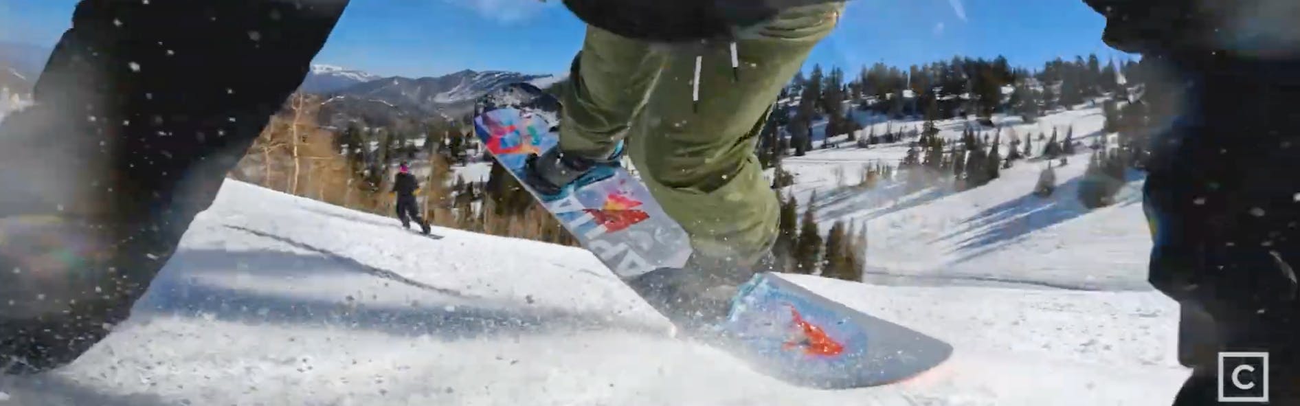 Closeup on a snowboarder buttering with the 2023 Capita Defenders of Awesome snowboard