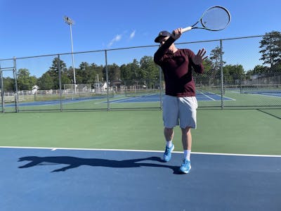 An expert playing tennis with Head Gravity MP Racquet.