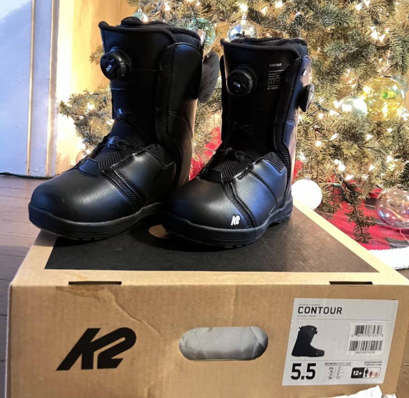 A pair of K2 Contour Snowboard boots sit on top of the box.