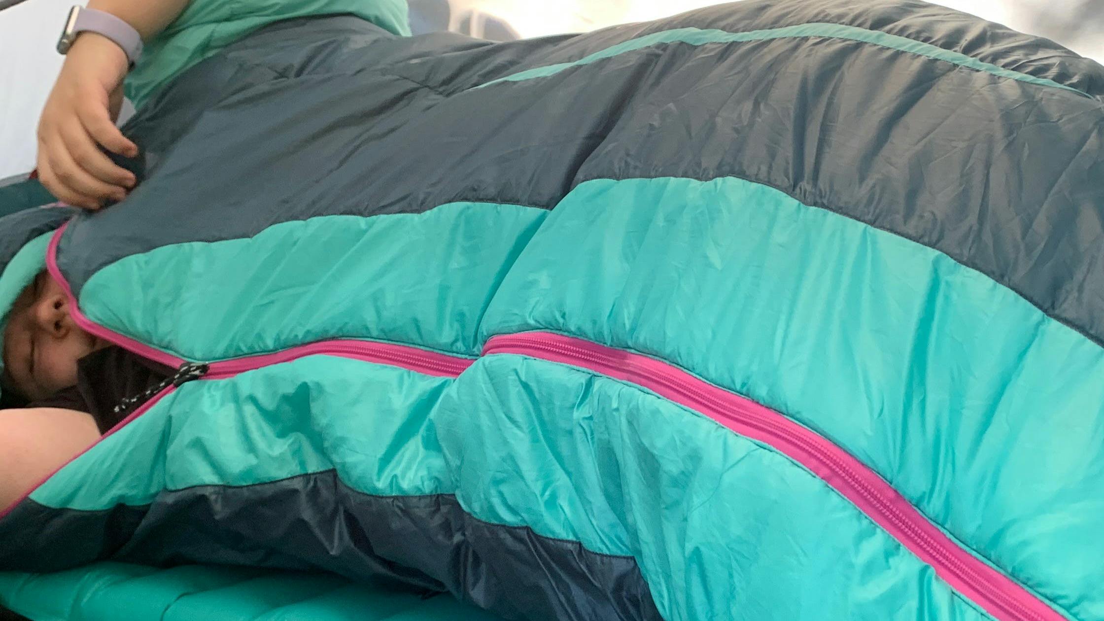 A woman in a tent in the Nemo Forte 35 Sleeping Bag.