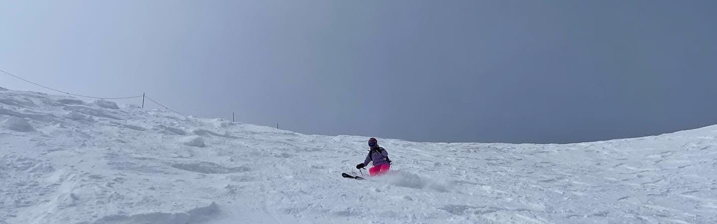 A woman skiing Highlands Bowl in Aspen with about 9" of Fresh snow.