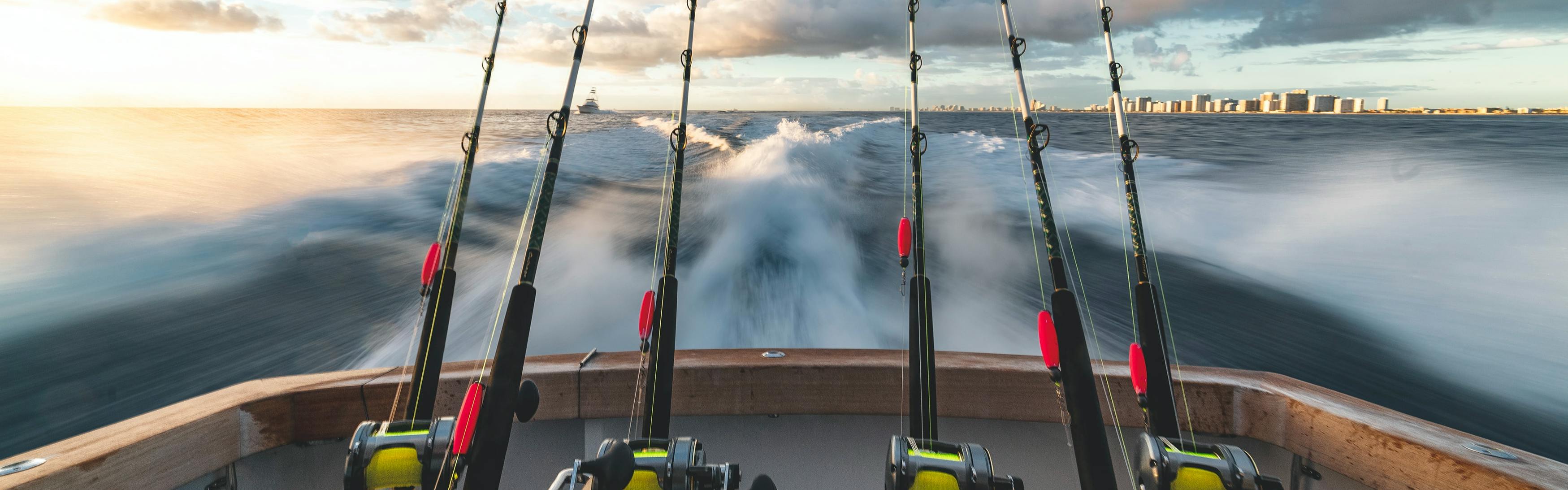 Six rods set up on the back of a boat in motion in the ocean