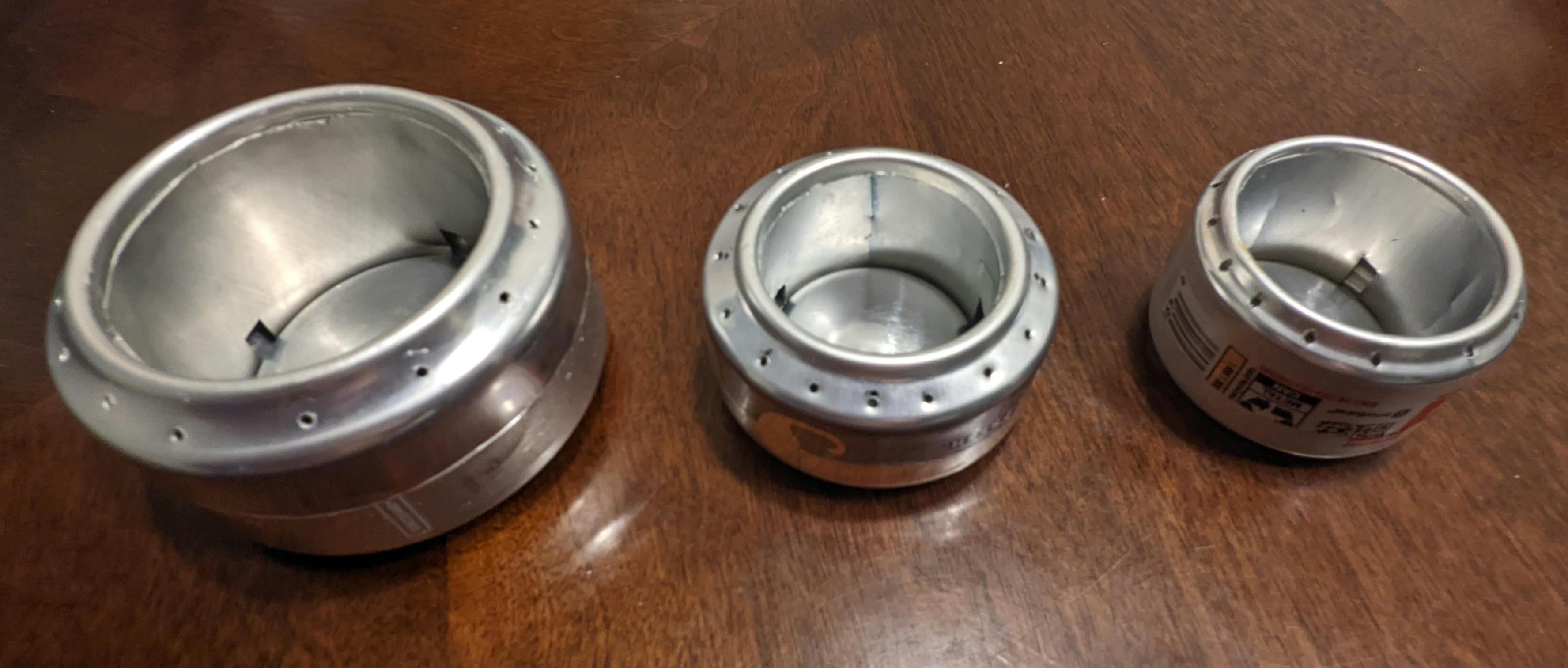 Three different examples of soda can stoves in different sizes. 