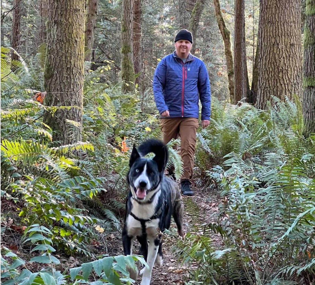A man walking his dog in the Spyder Glissade Jacket.