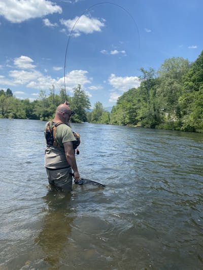 A man wade fishing on Tuckaseegee River, Sylva, North Carolina.