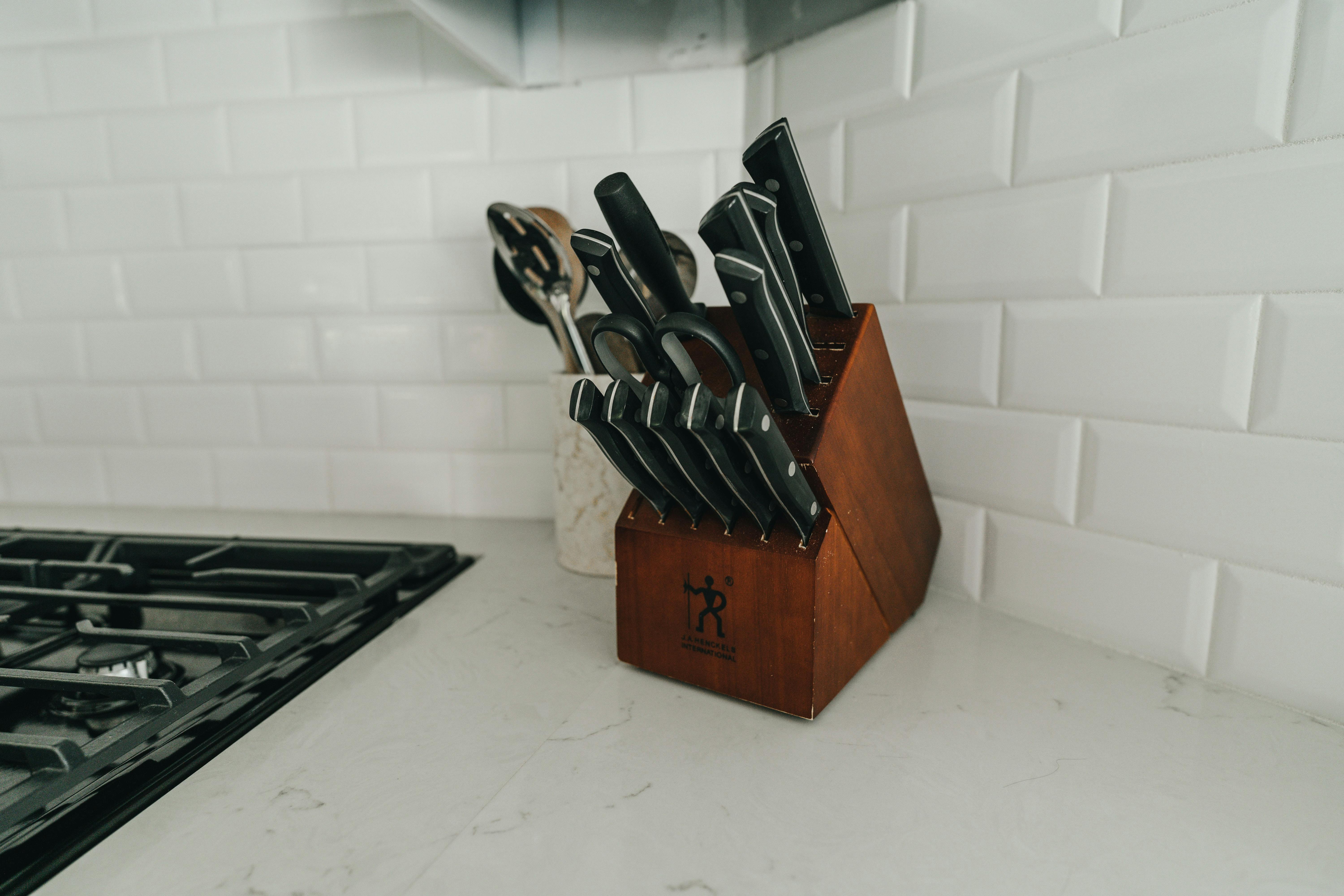 A knife block with the Zwilling knife logo holding knives and sitting on a counter. 