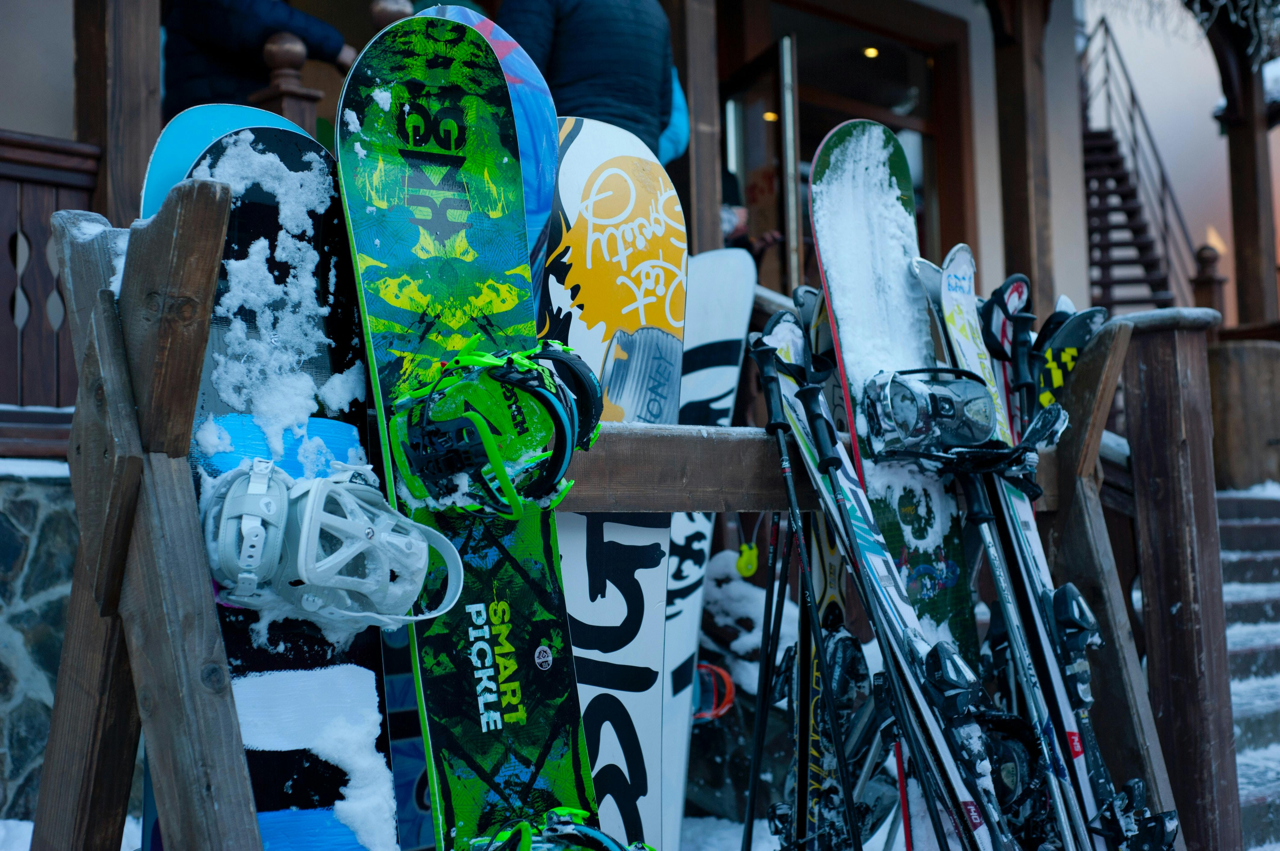Snowboards on rack outside a lodge.