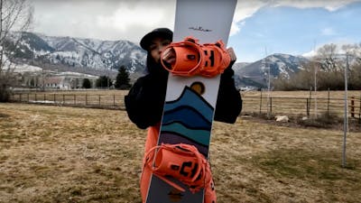 Snowboard Expert Sydney Johnson holding up the Nitro Drop snowboard