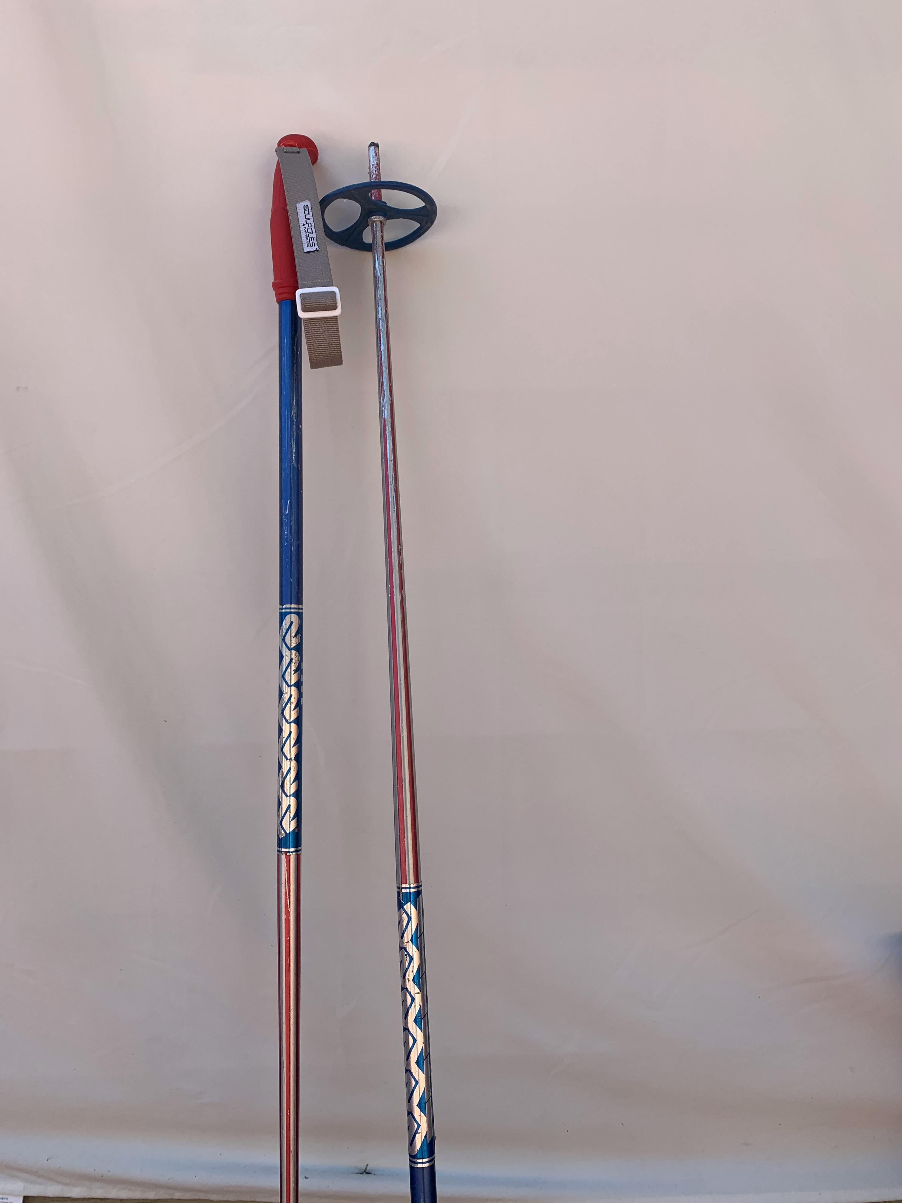 A pair of blue and red vintage ski poles