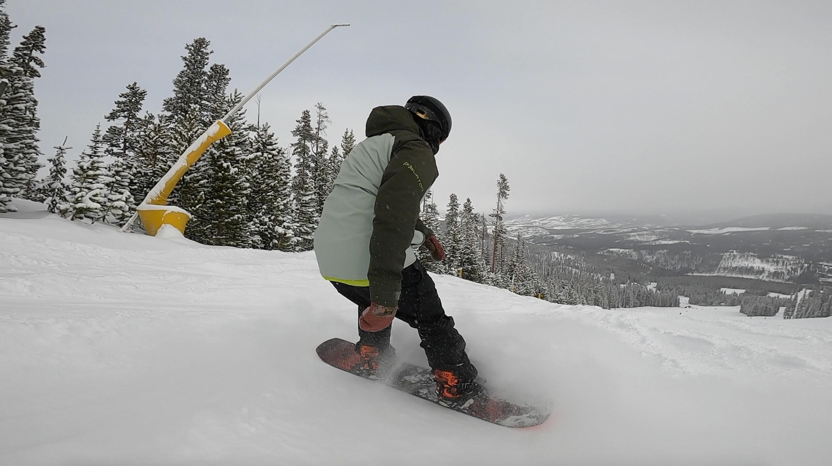A snowboarder executes a stop