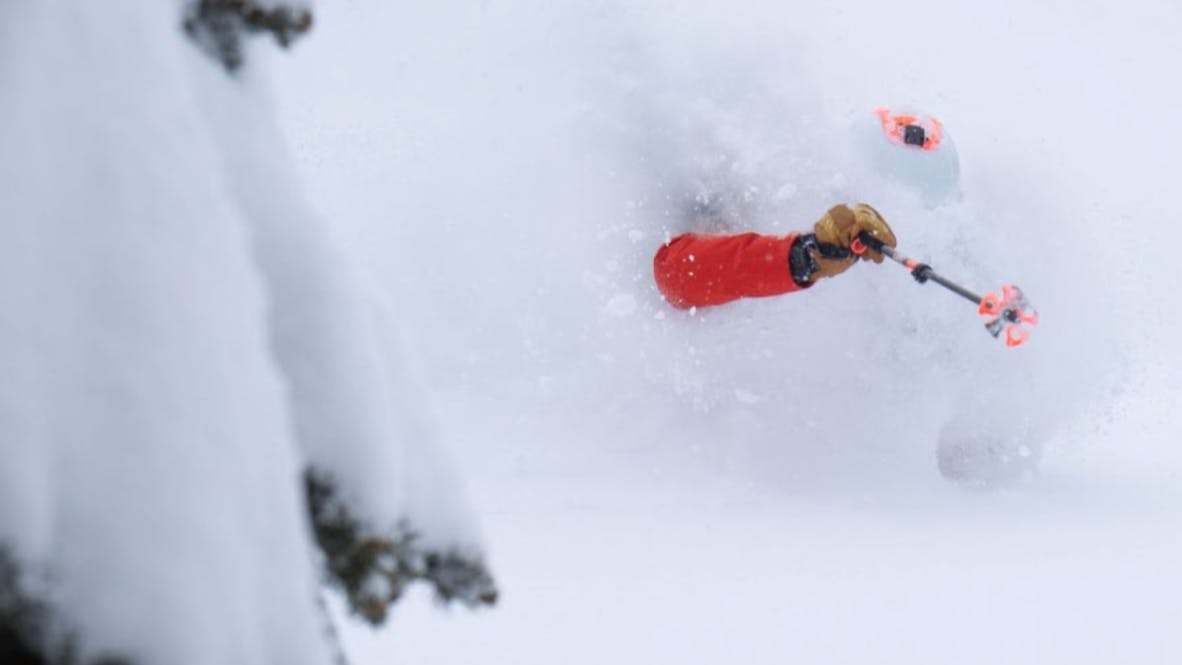 A man skiing in deep powder. 