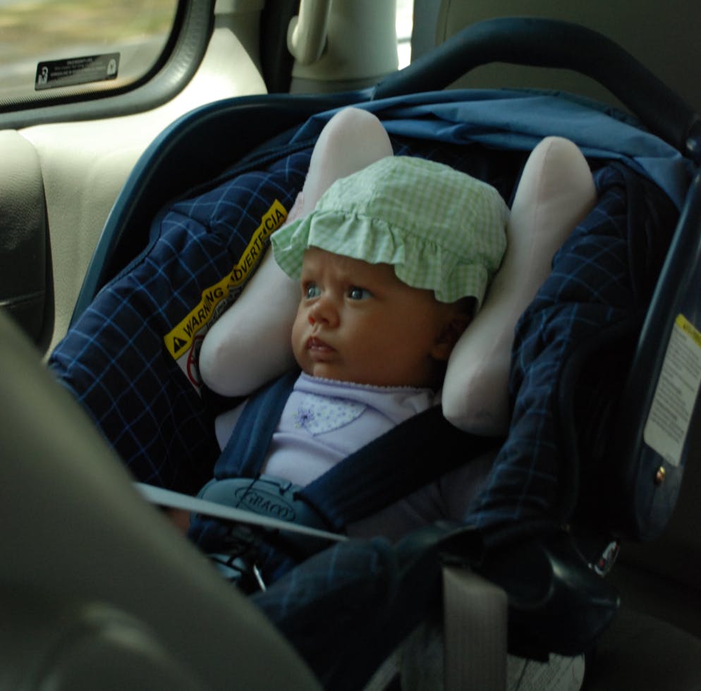 A baby in a car seat.