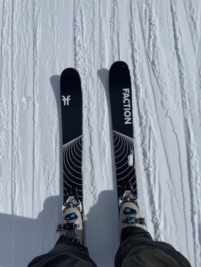 Top down view of ski boots and skis on a snowy run. 