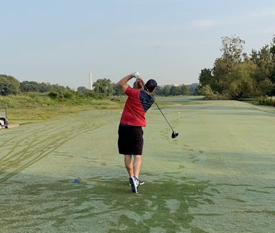A golfer golfing with the  Srixon ZX5 Driver.