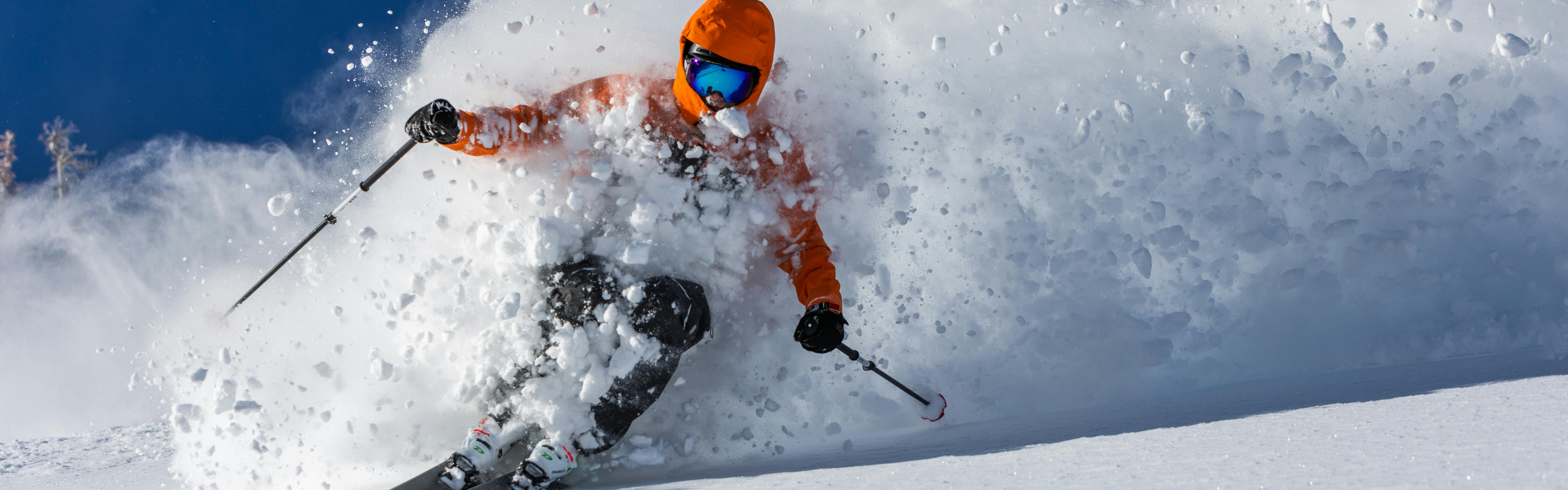 Pro skier Dash Longe makes a turn through a wave of powdery snow. 