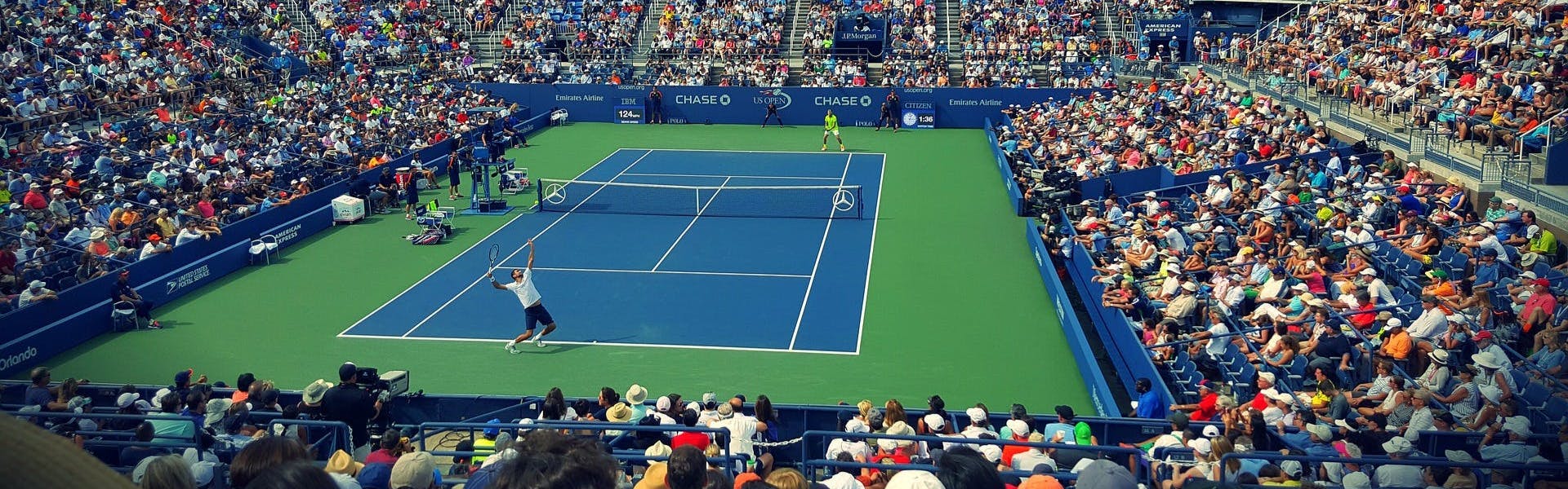 Man making a serve in a tennis match