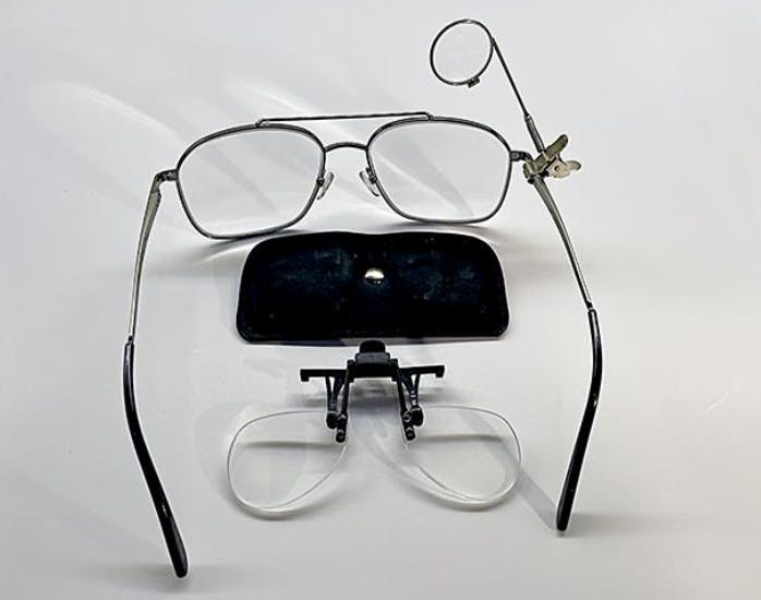 Eyeglasses with a magnifier attached.