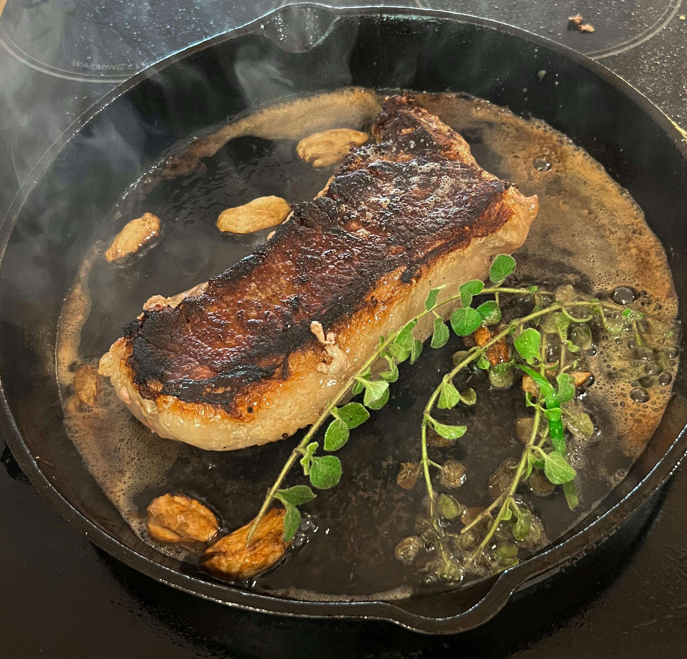 Steak sizzling in the pan