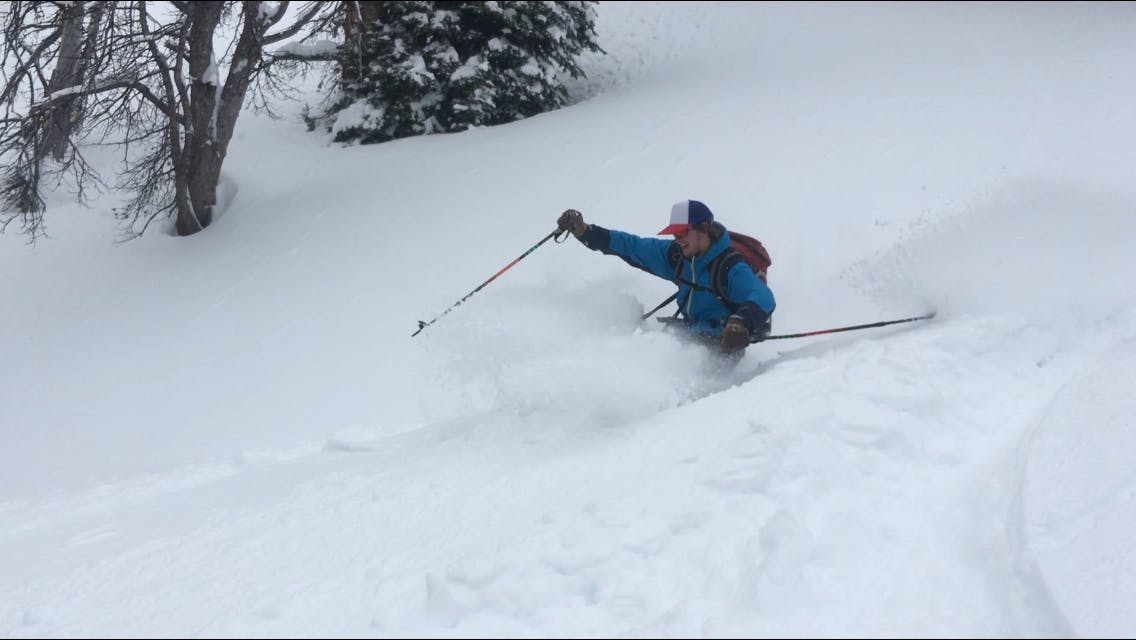 Skier smashing through powder