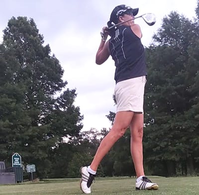 A woman swings the TaylorMade Stealth Fairway Wood.