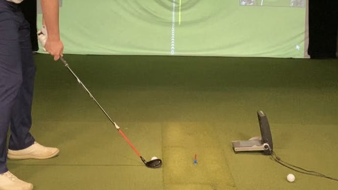 A man swinging the Callaway Apex 2021 Hybrid in a golf simulator.