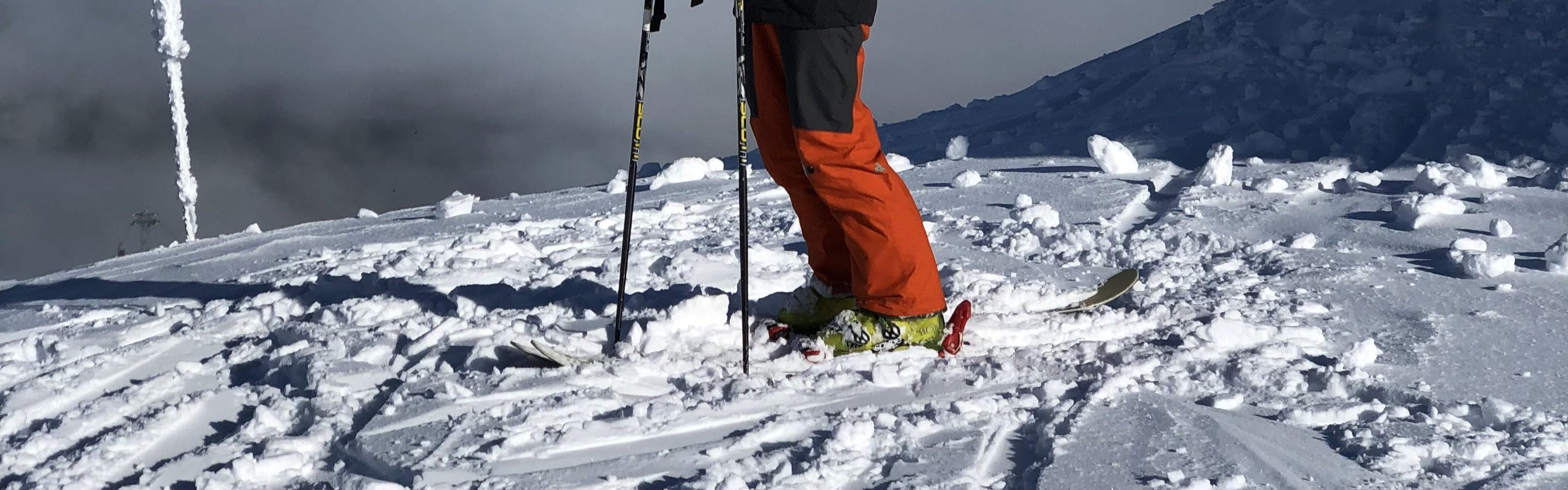 A skier standing at the top of the peak chair in whistler with CT 1.0 skis. 