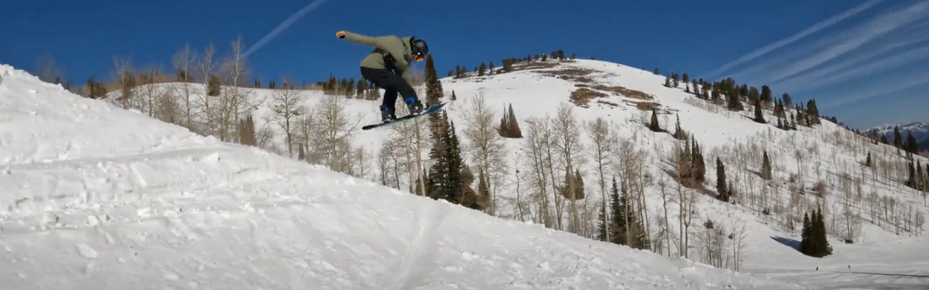 Snowboard Expert Spencer Storck jumping with the GNU Antigravity snowboard