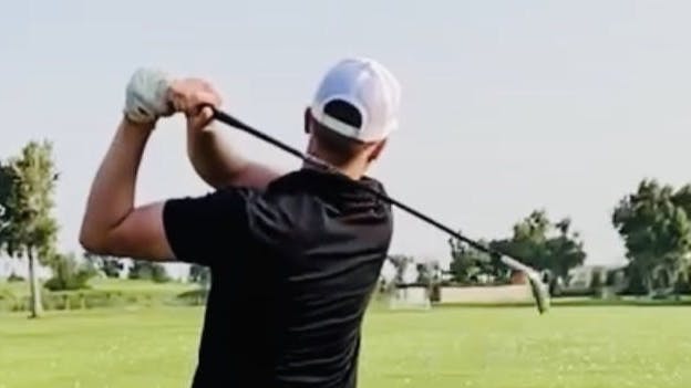 Curated expert Casey Stock swinging the Callaway Apex DCB Iron on a course.