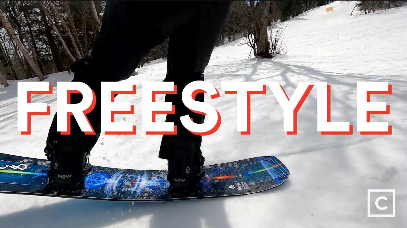Curated expert Franco DiRienzo buttering with the Lib Tech Golden Orca snowboard with a "Freestyle" graphic over the image