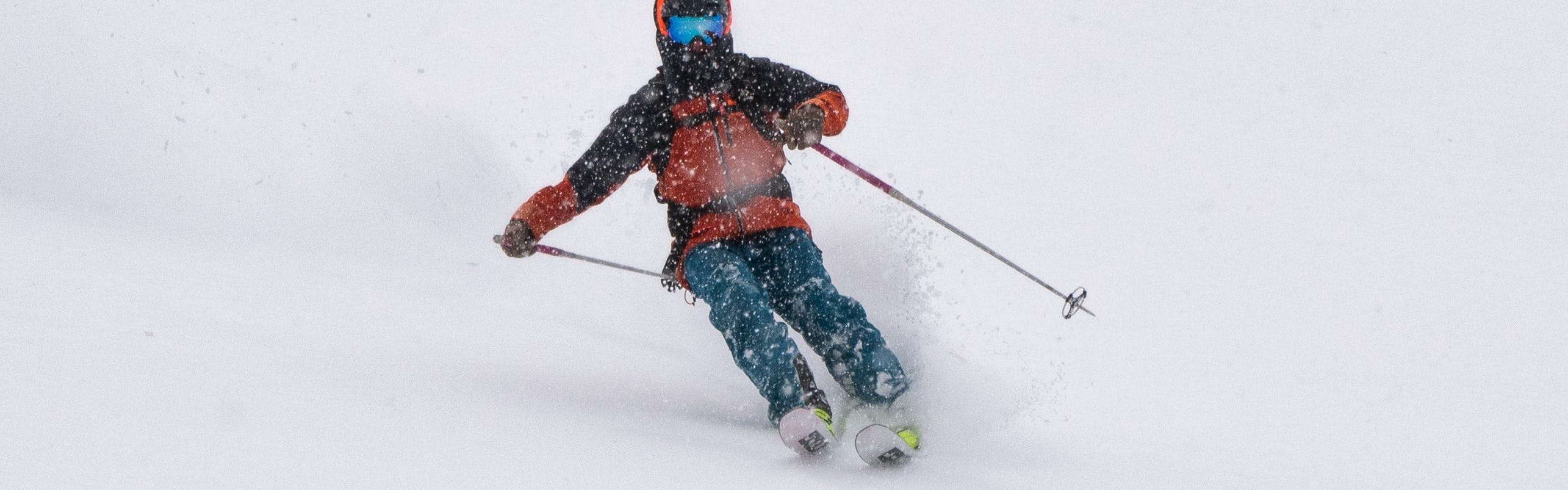 A skier turning down a snowy run. 