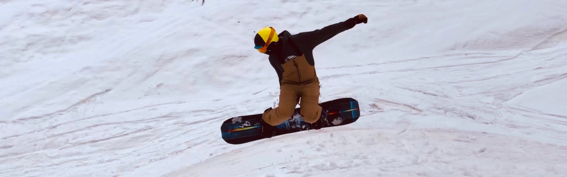 Nathan G. doing a snowboard jump.