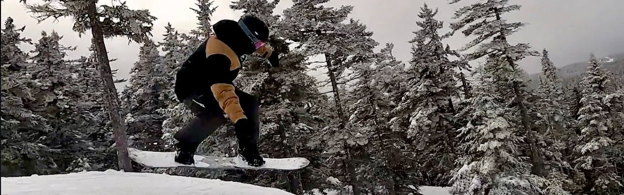 Curated expert Colby Henderson flying through the air on the Lib Tech Orca snowboard