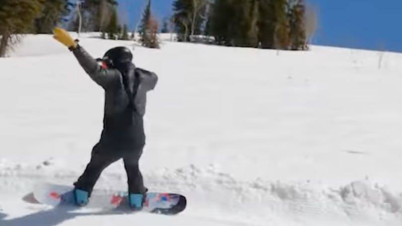 A snowboarder on the Capita Defenders of Awesome snowboard. 
