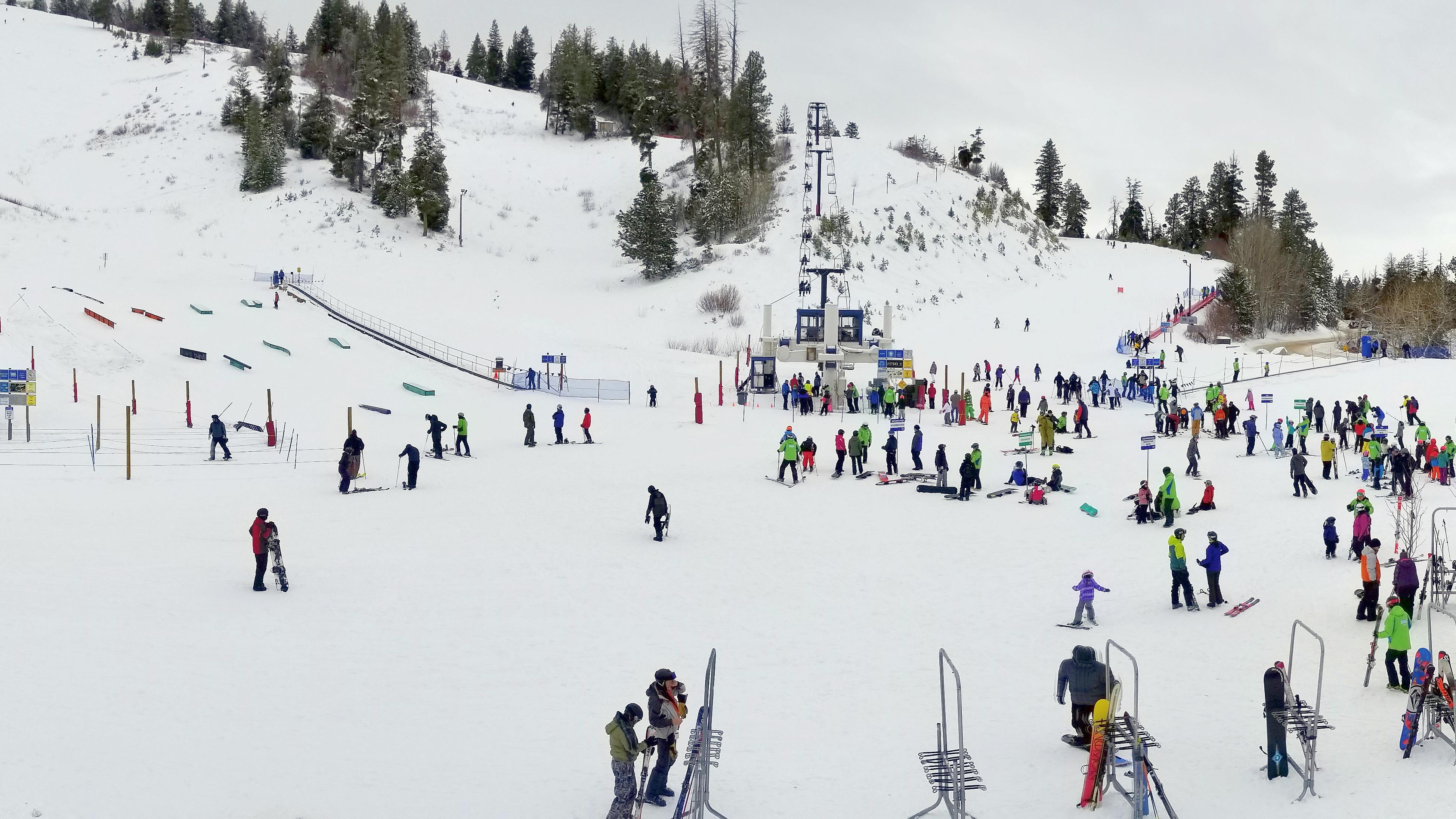 Several people at the base of a ski area. 