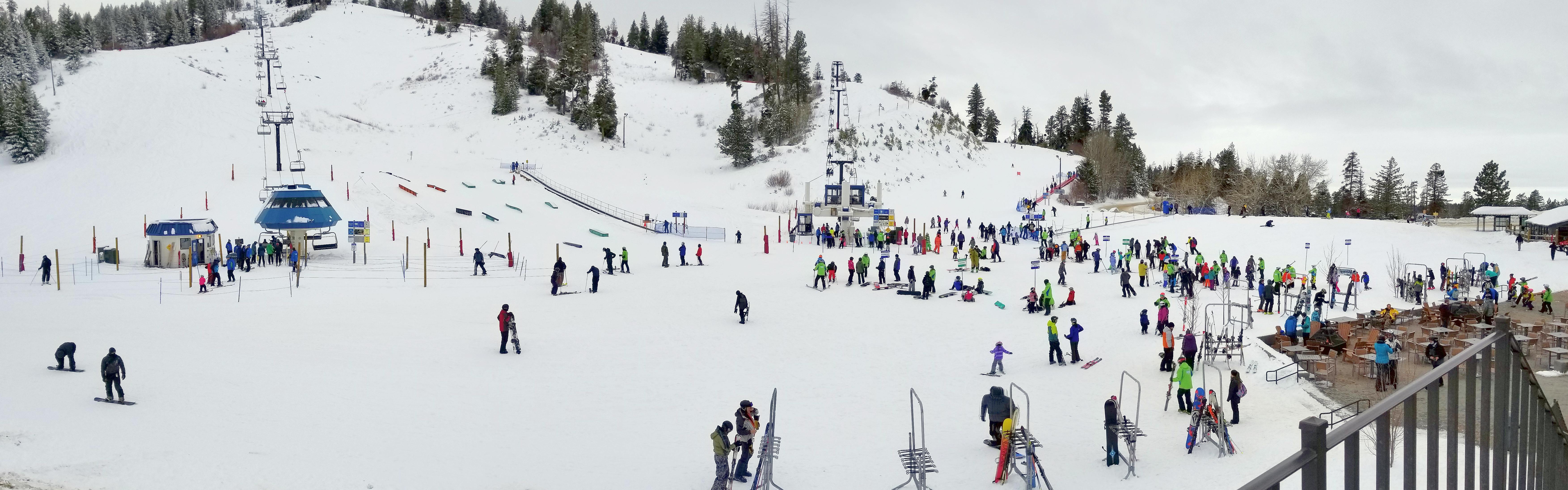 Several people at the base of a ski area. 