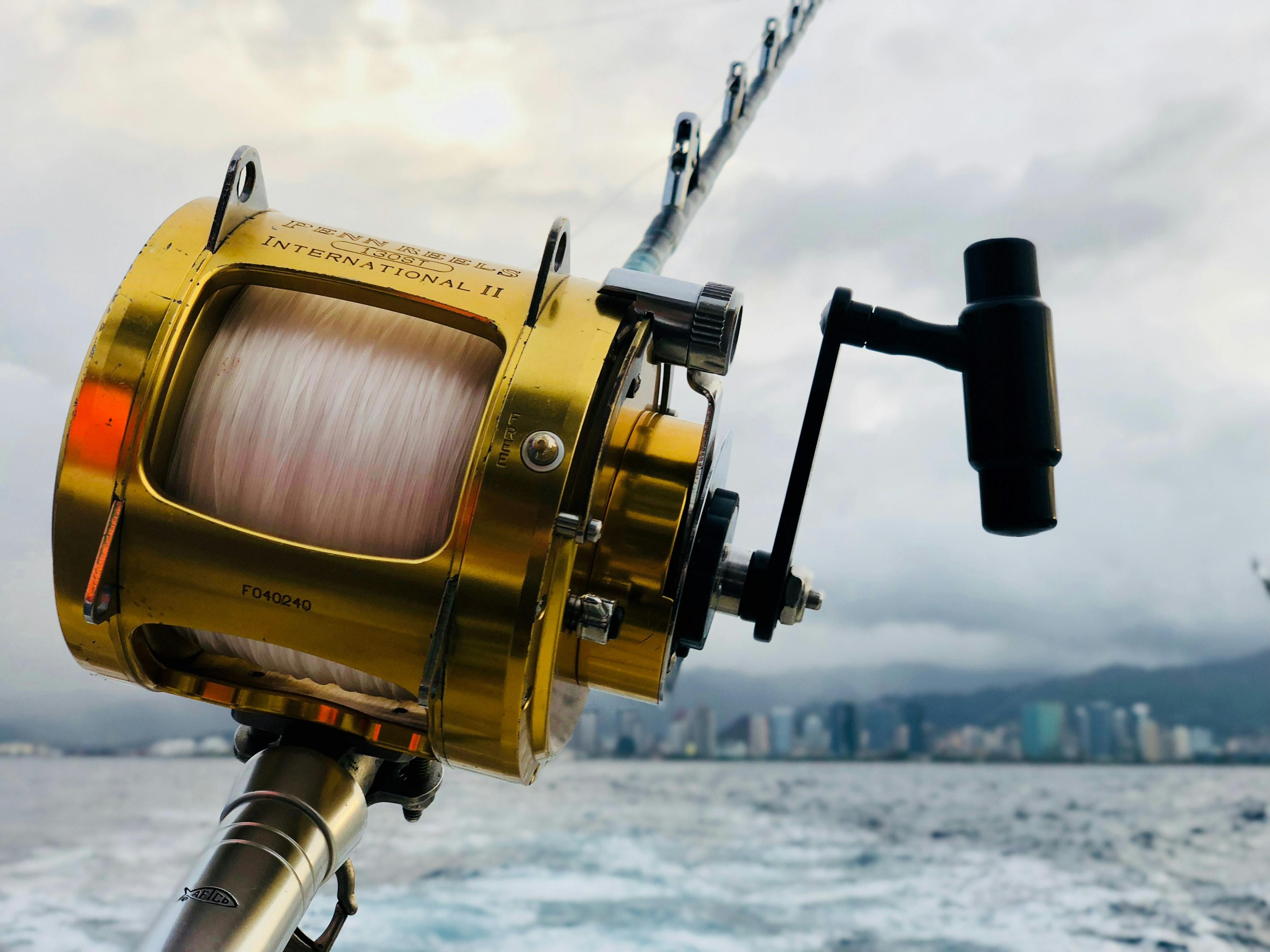 A closeup on a yellow saltwater fishing reel