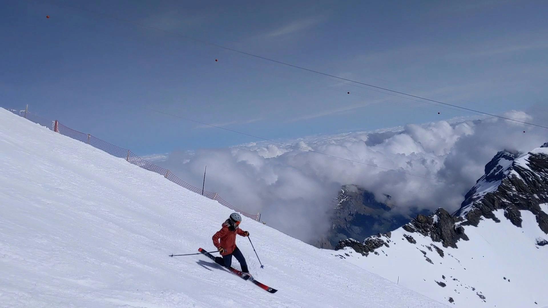 A skier turning down a ski run. 