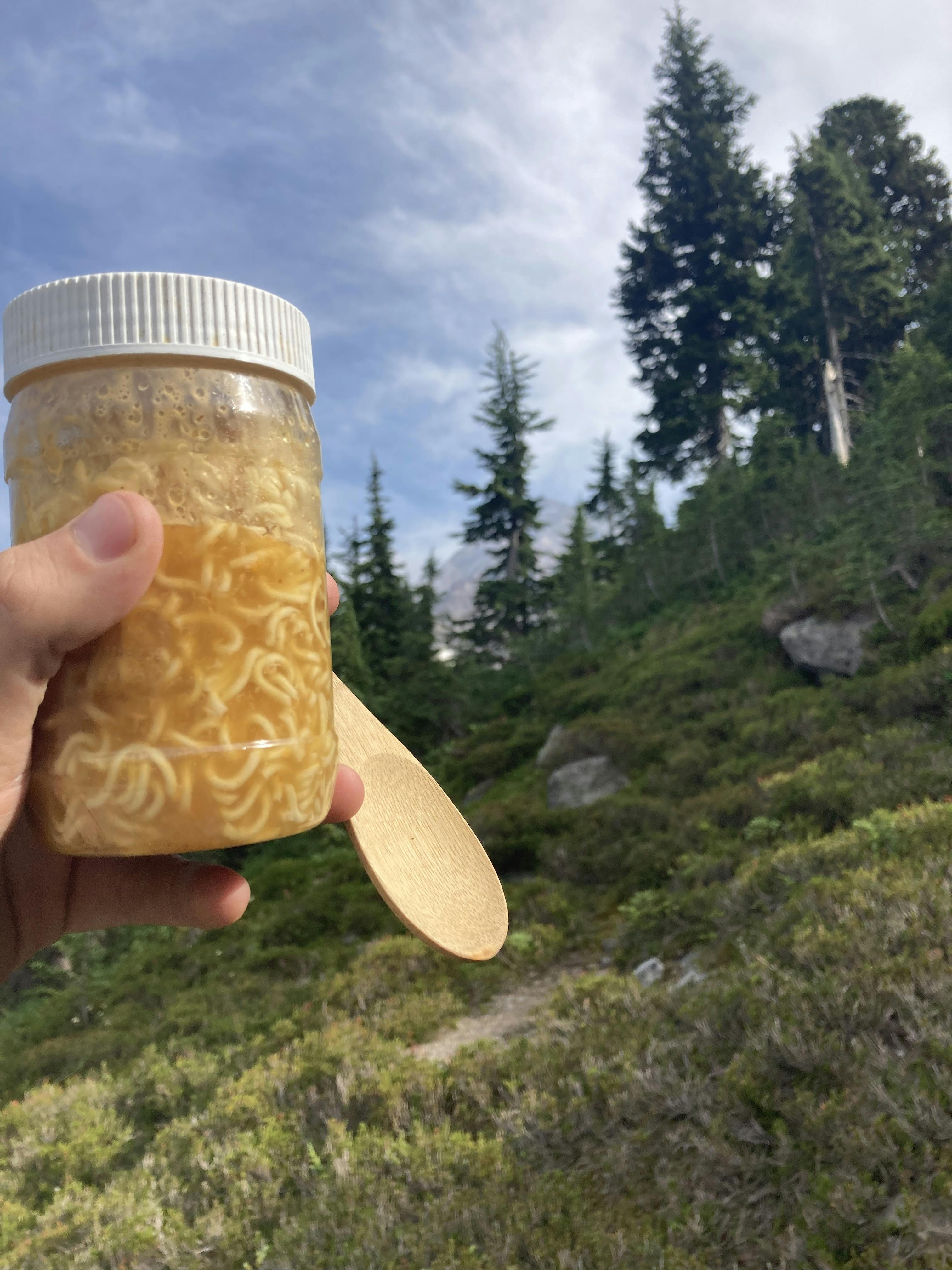 Wet ramen noodles in a plastic jar.