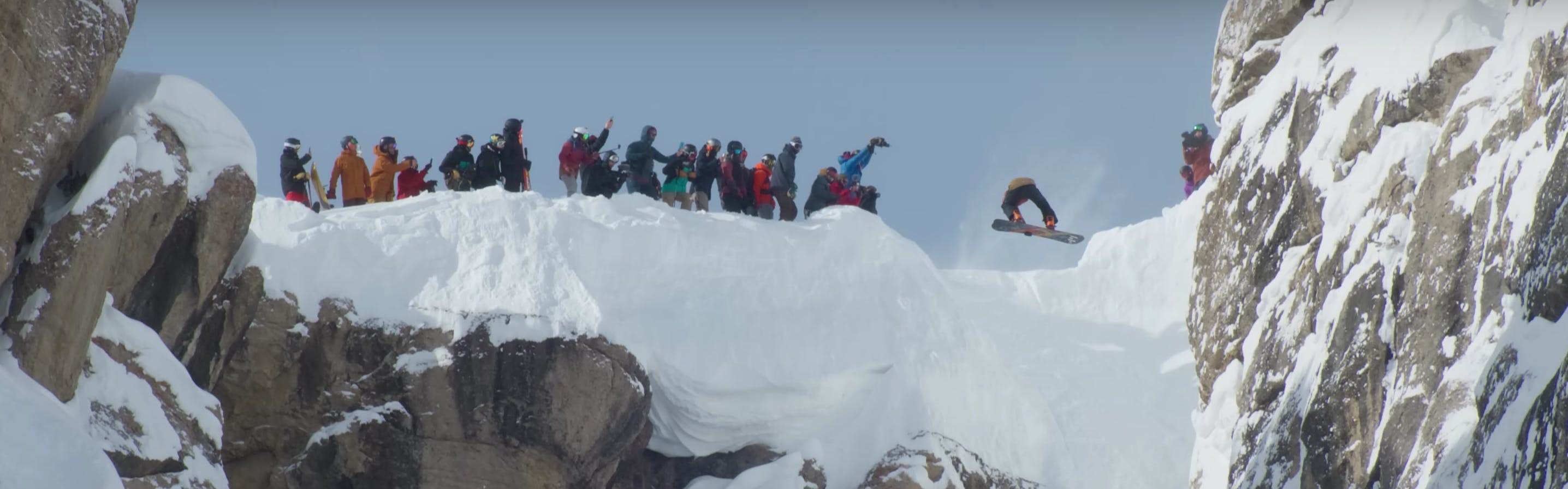 A snowboarder drops into Corbet's coulier for Kings and Queens of Corbet's. Photo comes from screenshot of Jackson Hole Mountain Resort's YouTube video "KINGS & QUEENS: MIND-BLOWING MOMENTS."