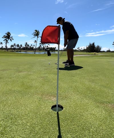 A man putting with the Cleveland Huntington Beach Soft #4 Putter.