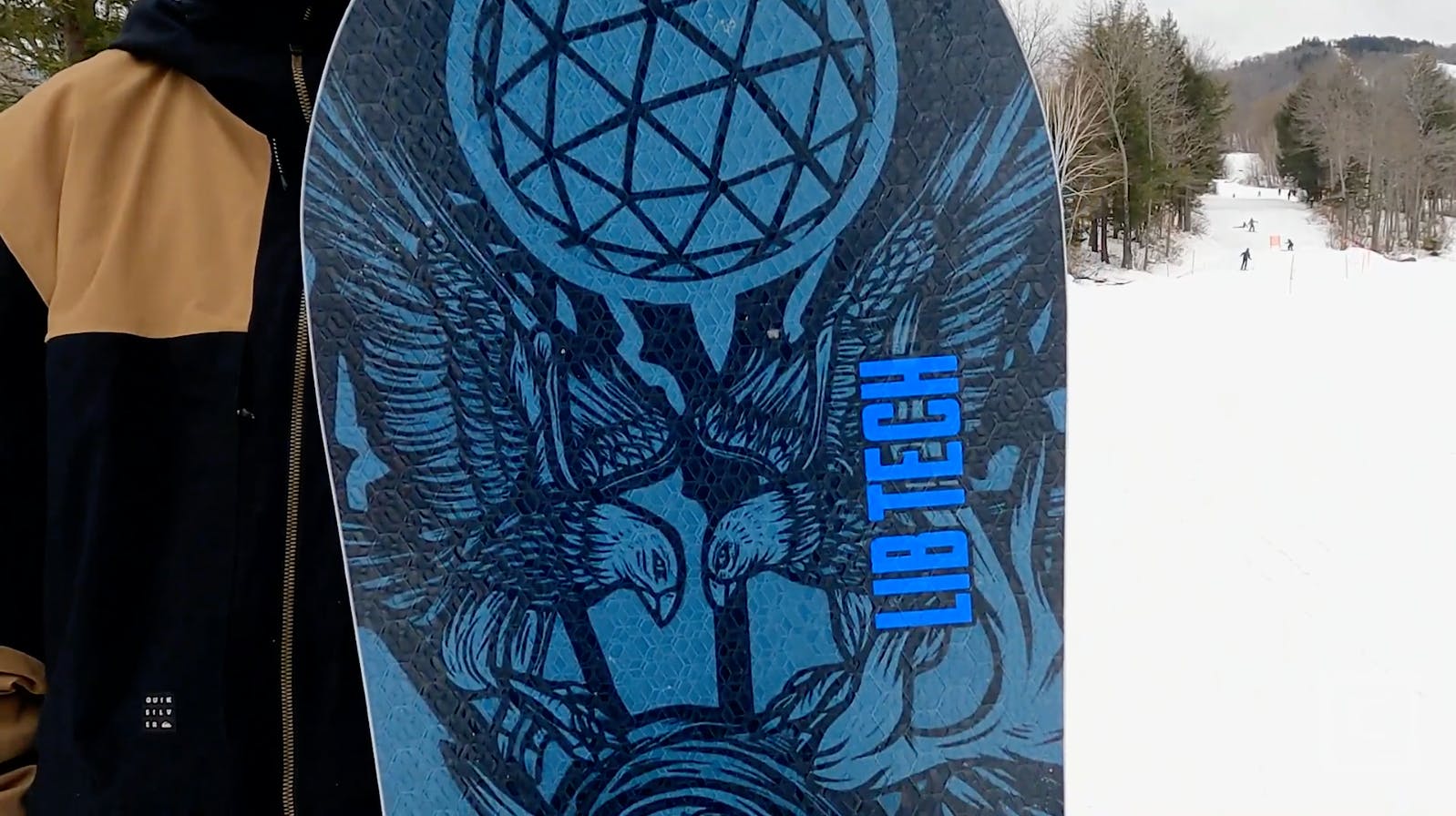 Closeup on the blue top graphics of the Lib Tech Terrain Wrecker snowboard