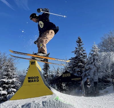 A skier hitting a pipe with a Smith Maze MIPS helmet on. 