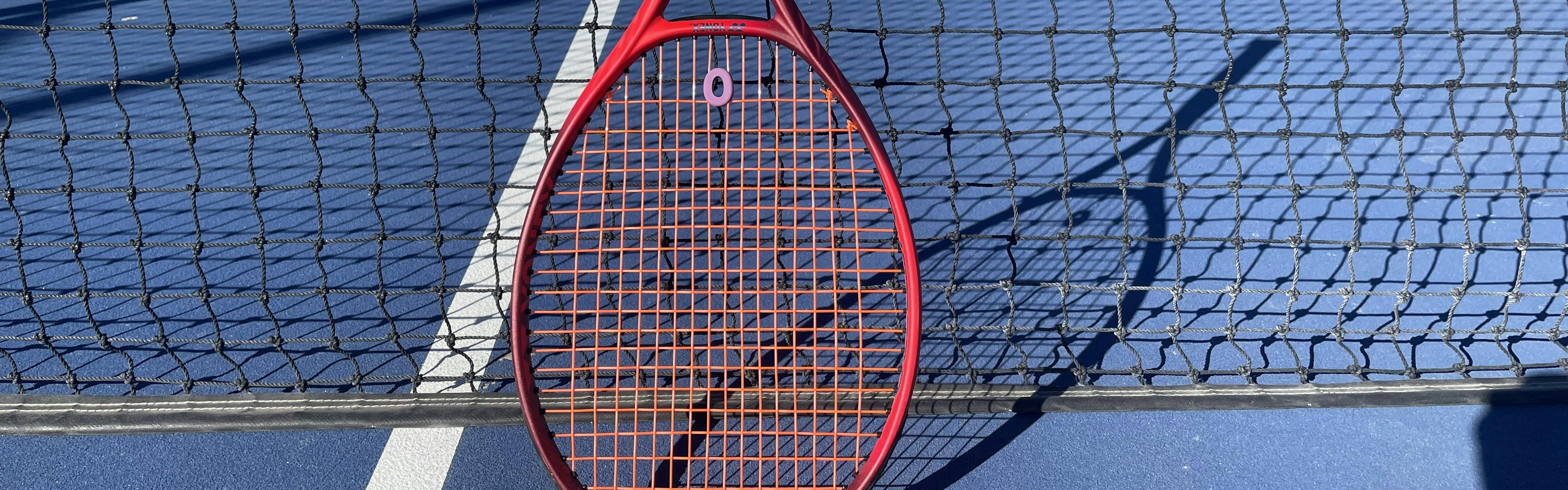 The Yonex VCore 98+ Racquet · Unstrung on a tennis court. 