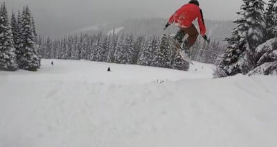 A skier jumping off a cat track. 