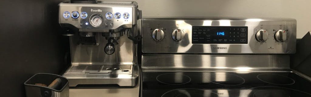 The Breville Barista Express on a counter in a kitchen.